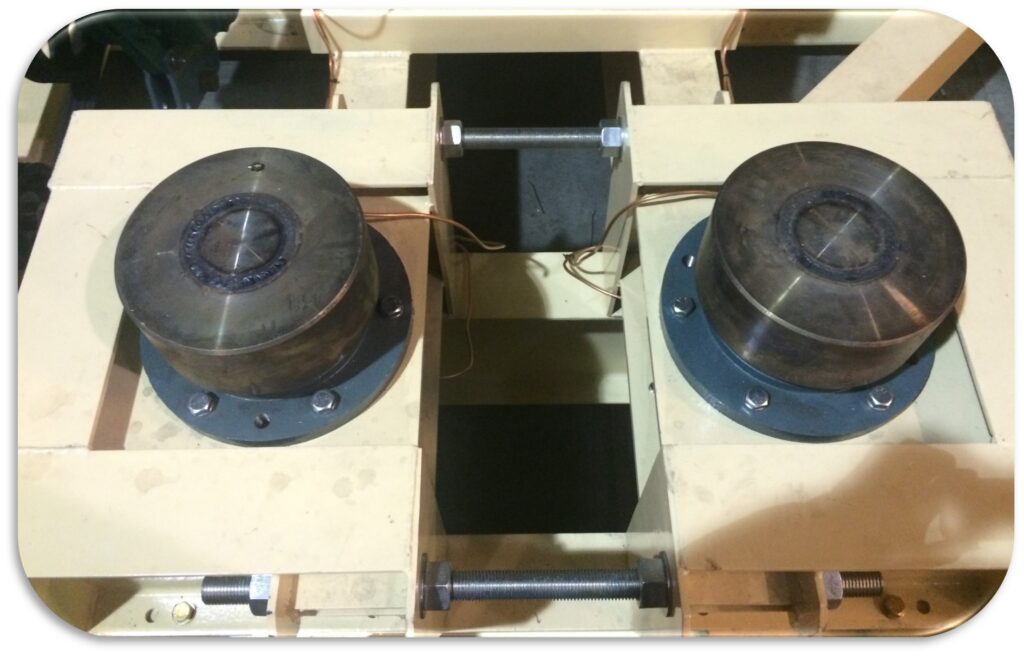 Twin thrust rollers are on each side of a dryer tire.