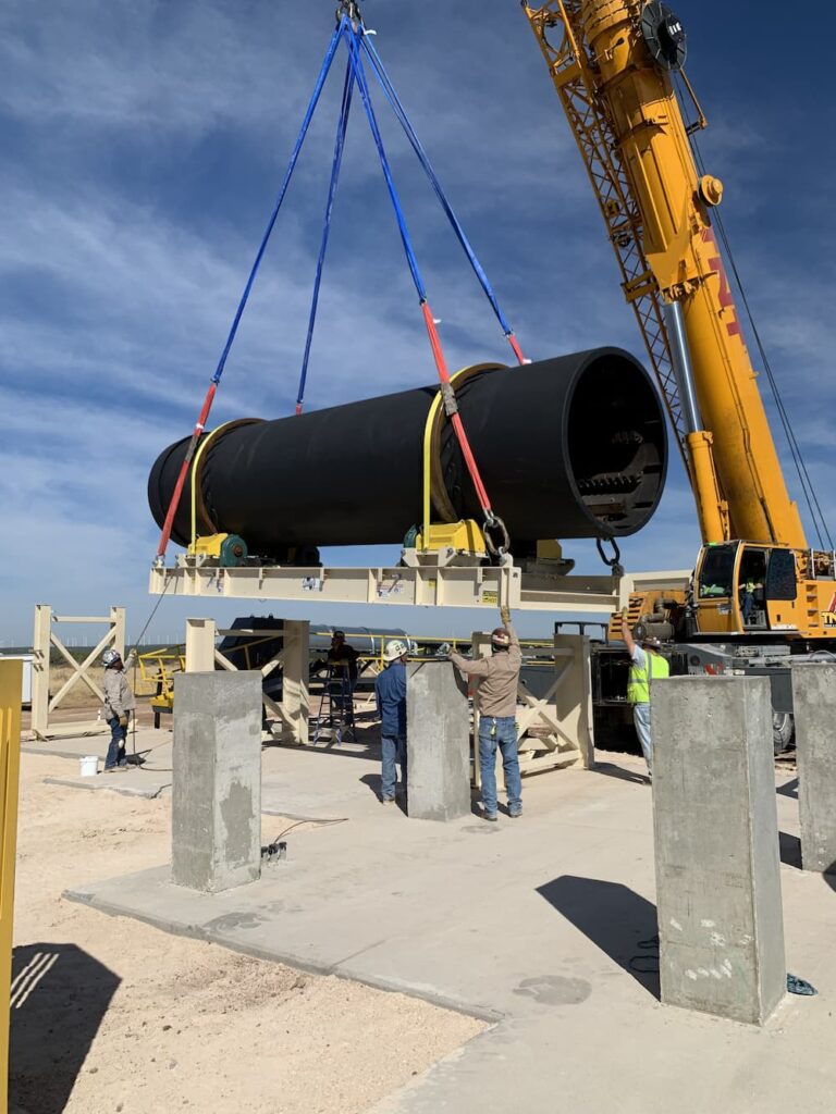Crane lowering a Tarmac dryer into place at a new calcium drying facility